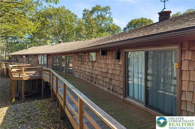 a view of a house with a yard balcony and swimming pool