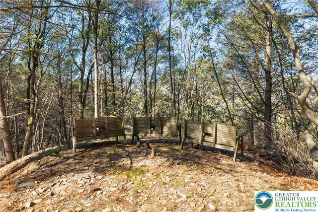 a kitchen with stainless steel appliances granite countertop a refrigerator a stove and a sink with wooden floor