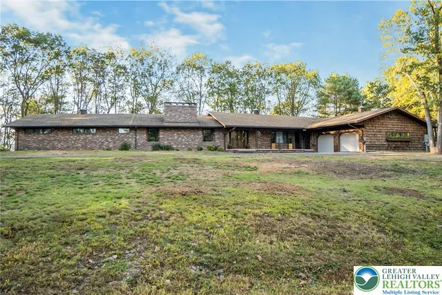 a kitchen with stainless steel appliances granite countertop a sink a granite counter tops and a potted plant