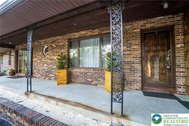 a living room with furniture and a piano