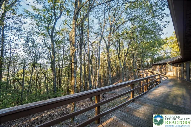 a dining room with furniture and a floor to ceiling window