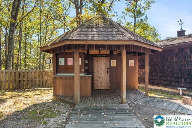 a view of a chairs and table in backyard of the house