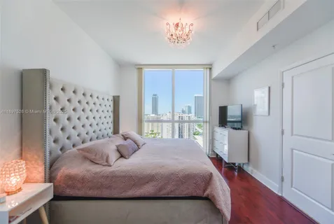 a living room with furniture kitchen view and a refrigerator