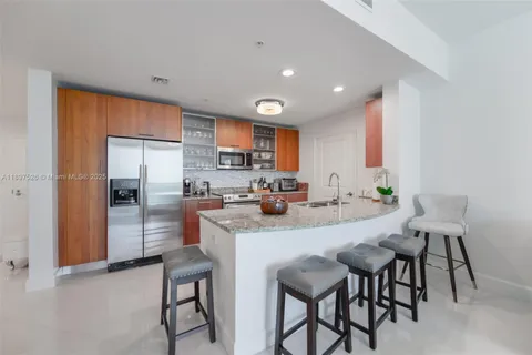 a hallway with table and white cabinets