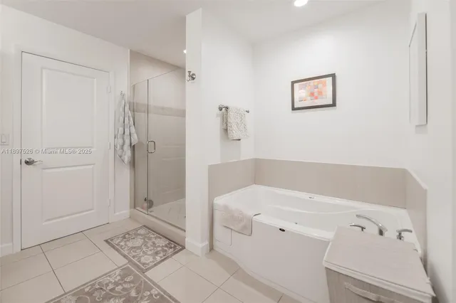 a bathroom with a bathtub and a shower