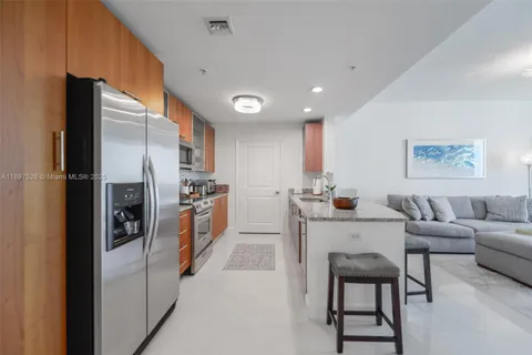 a kitchen with a refrigerator and table