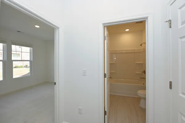 a bathroom with a bathtub shower sink vanity and toilet