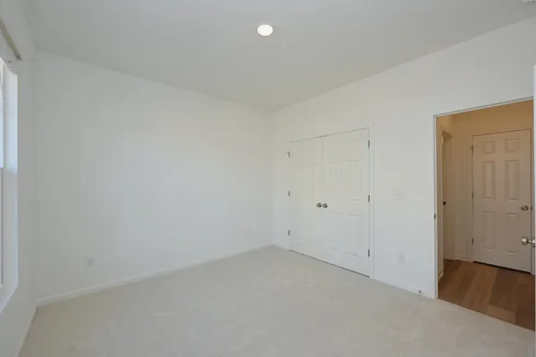 a view of kitchen with kitchen island granite countertop sink and refrigerator