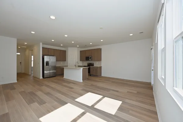 a view of kitchen with microwave oven stove and cabinets