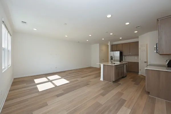a large kitchen with stainless steel appliances kitchen island granite countertop a sink and cabinets