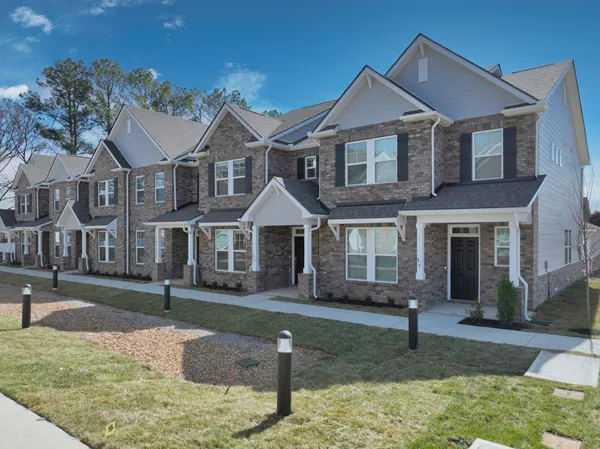 a front view of a house with a yard