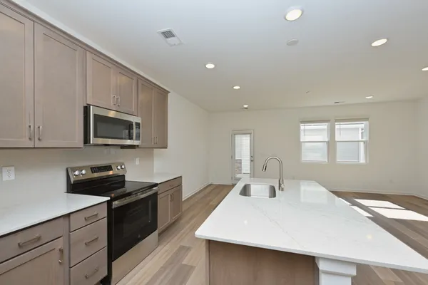 a kitchen with a sink and a refrigerator