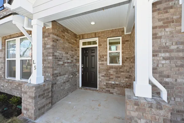 a view of front door of a house with windows
