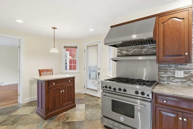 a kitchen with granite countertop a stove and a sink