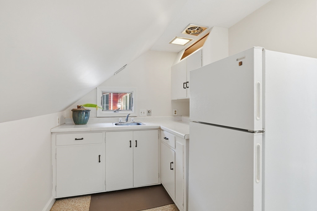 68 Monson Road Wilbraham, MA 01095 - Photo 22 of 39 a kitchen with a sink a refrigerator and cabinets
