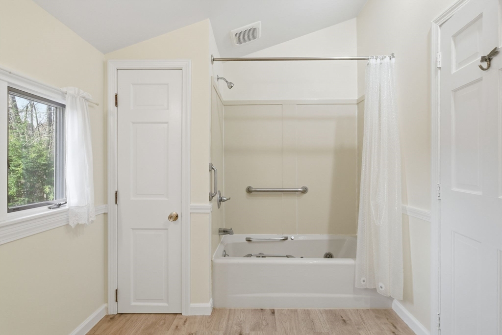 68 Monson Road Wilbraham, MA 01095 - Photo 28 of 39 a bathroom with a bathtub a sink a vanity and a window
