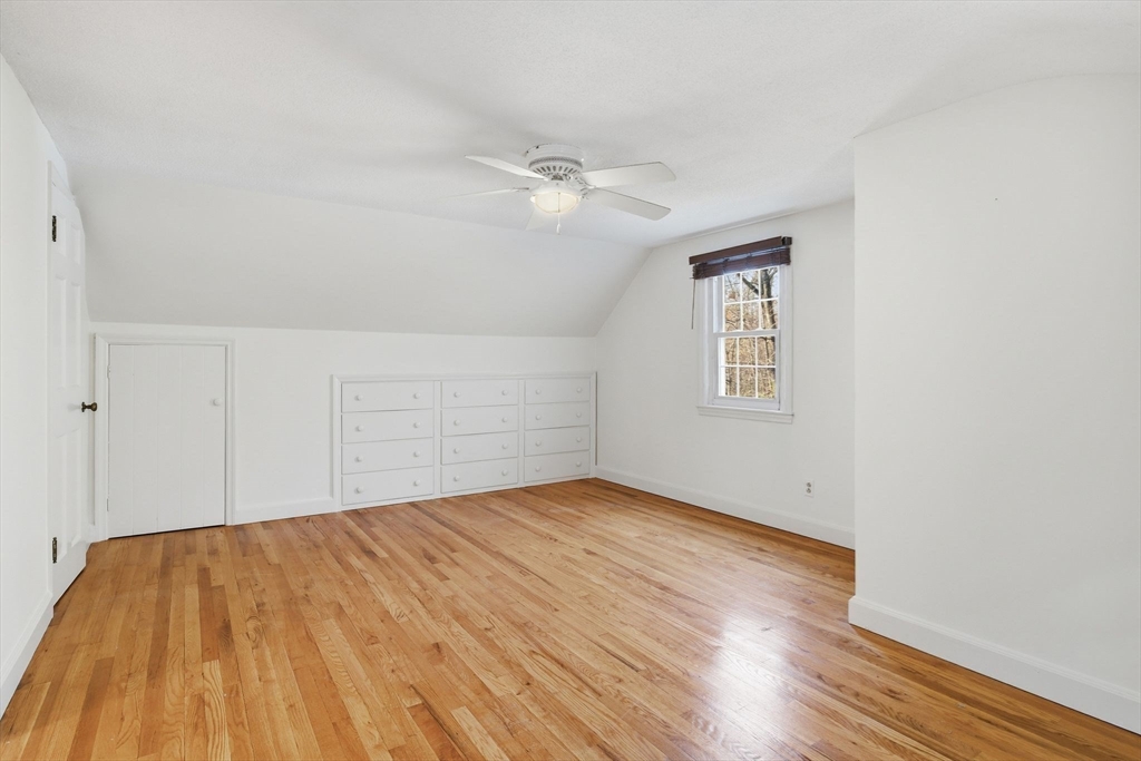 68 Monson Road Wilbraham, MA 01095 - Photo 30 of 39 an empty room with wooden floor ceiling fan and windows