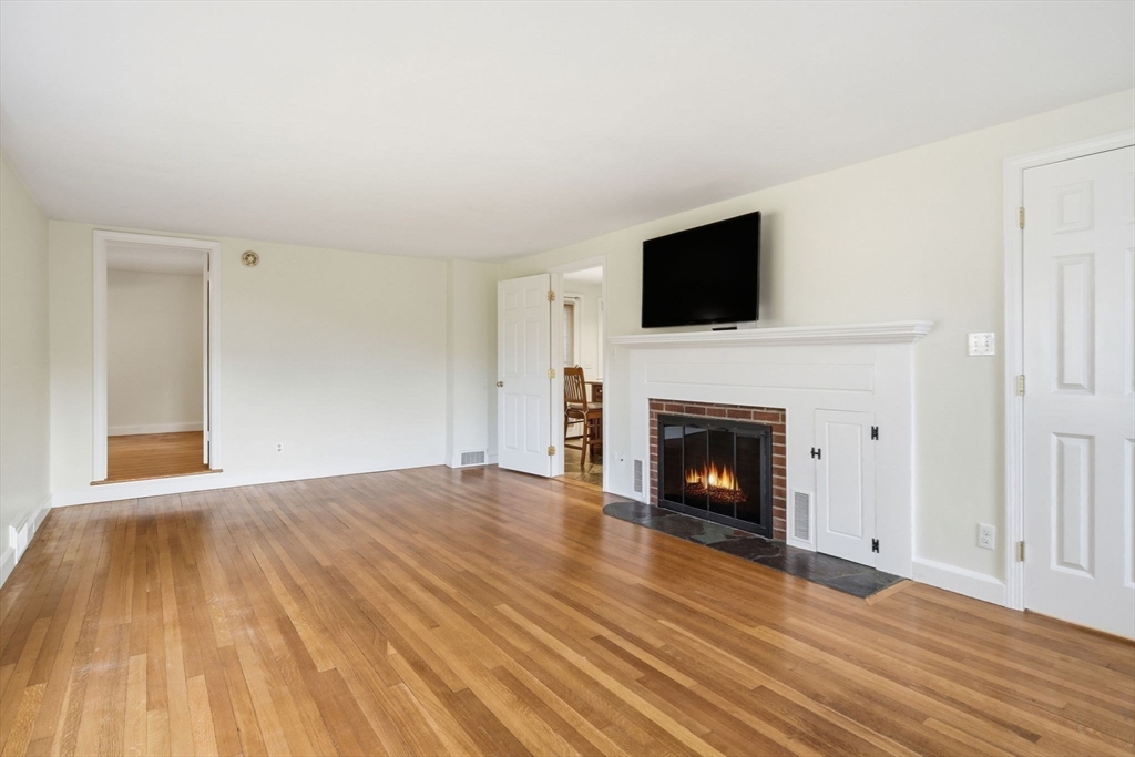 68 Monson Road Wilbraham, MA 01095 - Photo 5 of 39 a view of empty room with wooden floor and fireplace