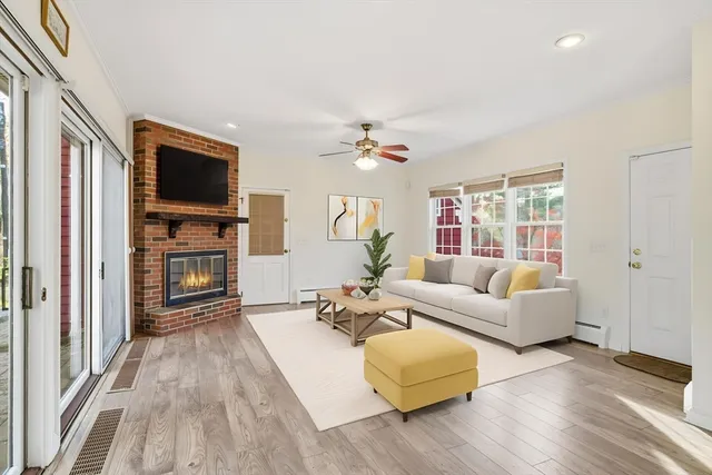 a living room with furniture fireplace and flat screen tv