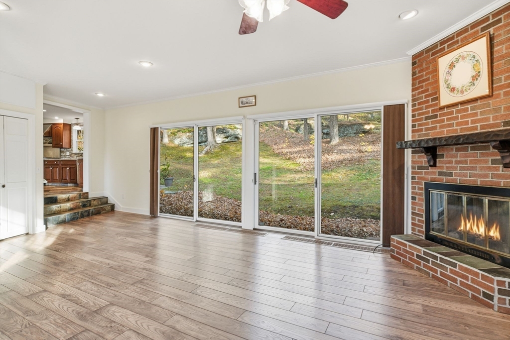 68 Monson Road Wilbraham, MA 01095 - Photo 9 of 39 a view of an empty room with wooden floor and a fireplace