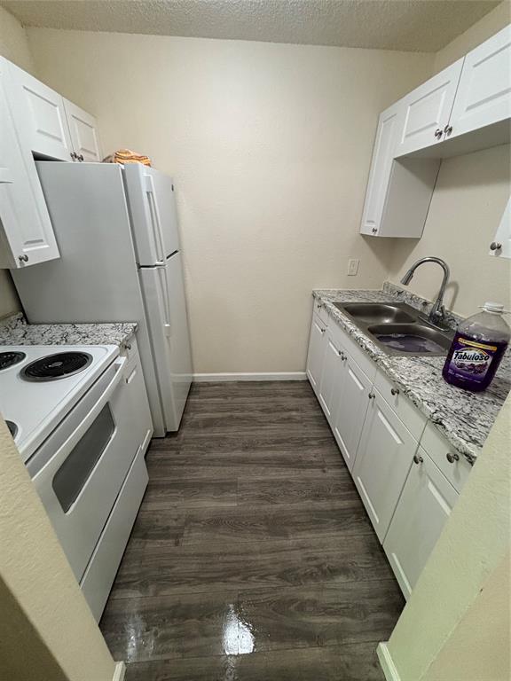 8127 Stonehurst Street, Unit 4 Dallas, TX 75217 - Photo 5 of 6 a kitchen with sink stove and refrigerator