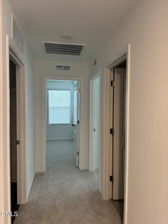 a view of an empty room and closet area