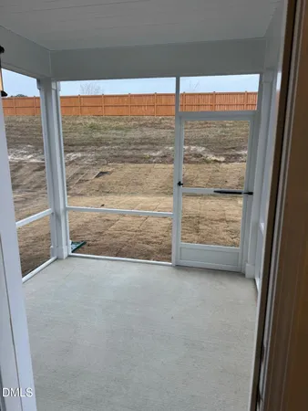 a view of an empty room with a floor to ceiling window