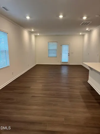 a view of room and hall with wooden floor