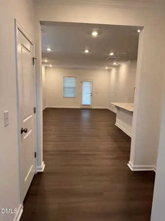 a view of a room with wooden floor and window