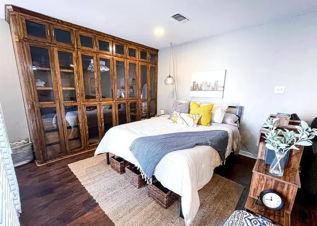 a bed sitting in a bedroom next to a window