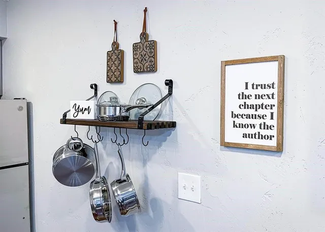 a kitchen with stainless steel appliances a sink a stove a refrigerator cabinets and furniture