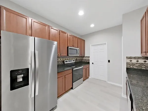 a large bathroom with a granite countertop sink and a mirror