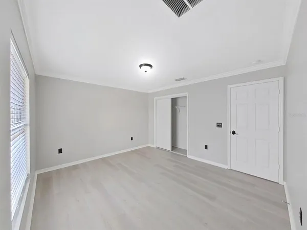 a spacious bathroom with a toilet sink and mirror