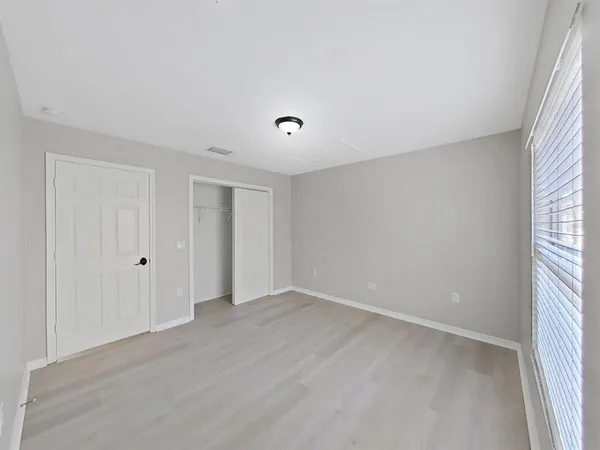 an empty room with a empty space and windows