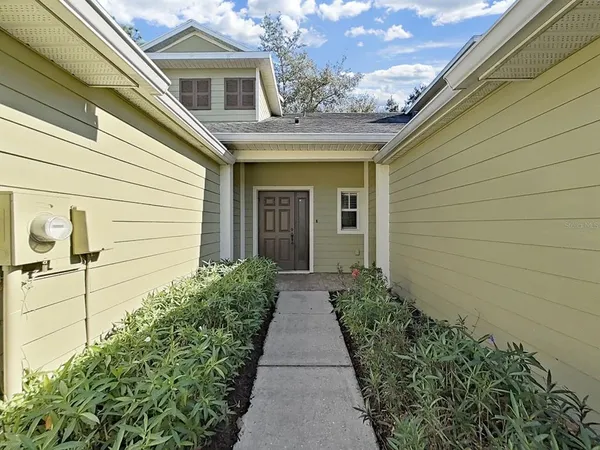 a front view of a house with garden