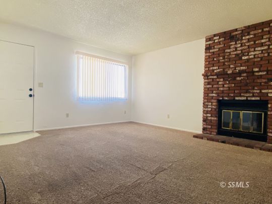 1004 West Graaf Avenue Ridgecrest, CA 93555 - Photo 17 of 21 a view of an empty room with a fireplace
