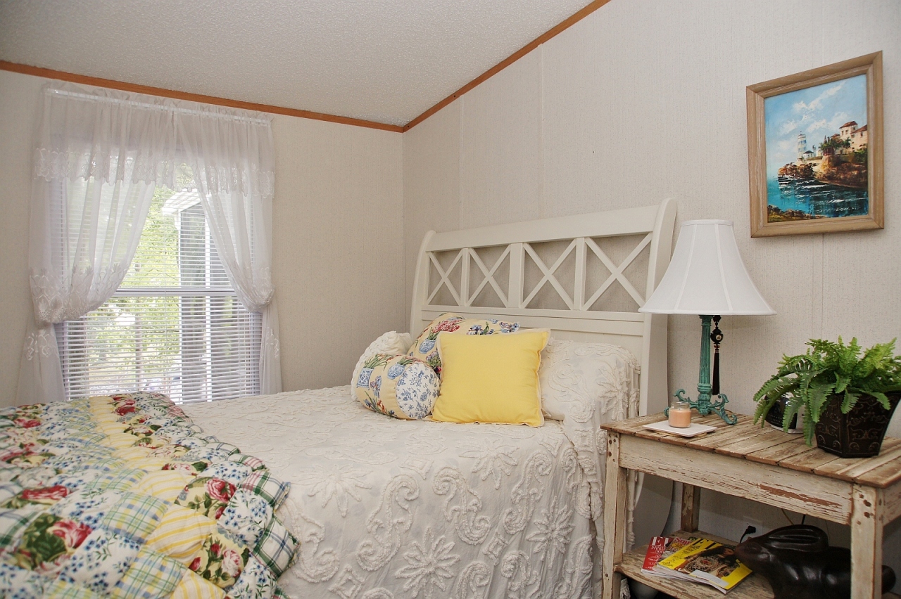 180 Cove Road Penhook, VA 24137 - Photo 13 of 33 a bedroom with a bed and a lamp on dresser