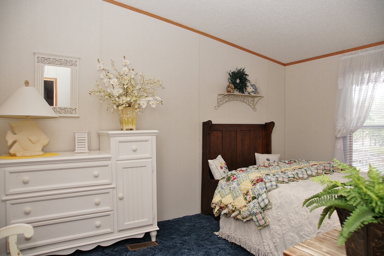 180 Cove Road Penhook, VA 24137 - Photo 14 of 33 a bedroom with a bed and a potted plant on the dresser