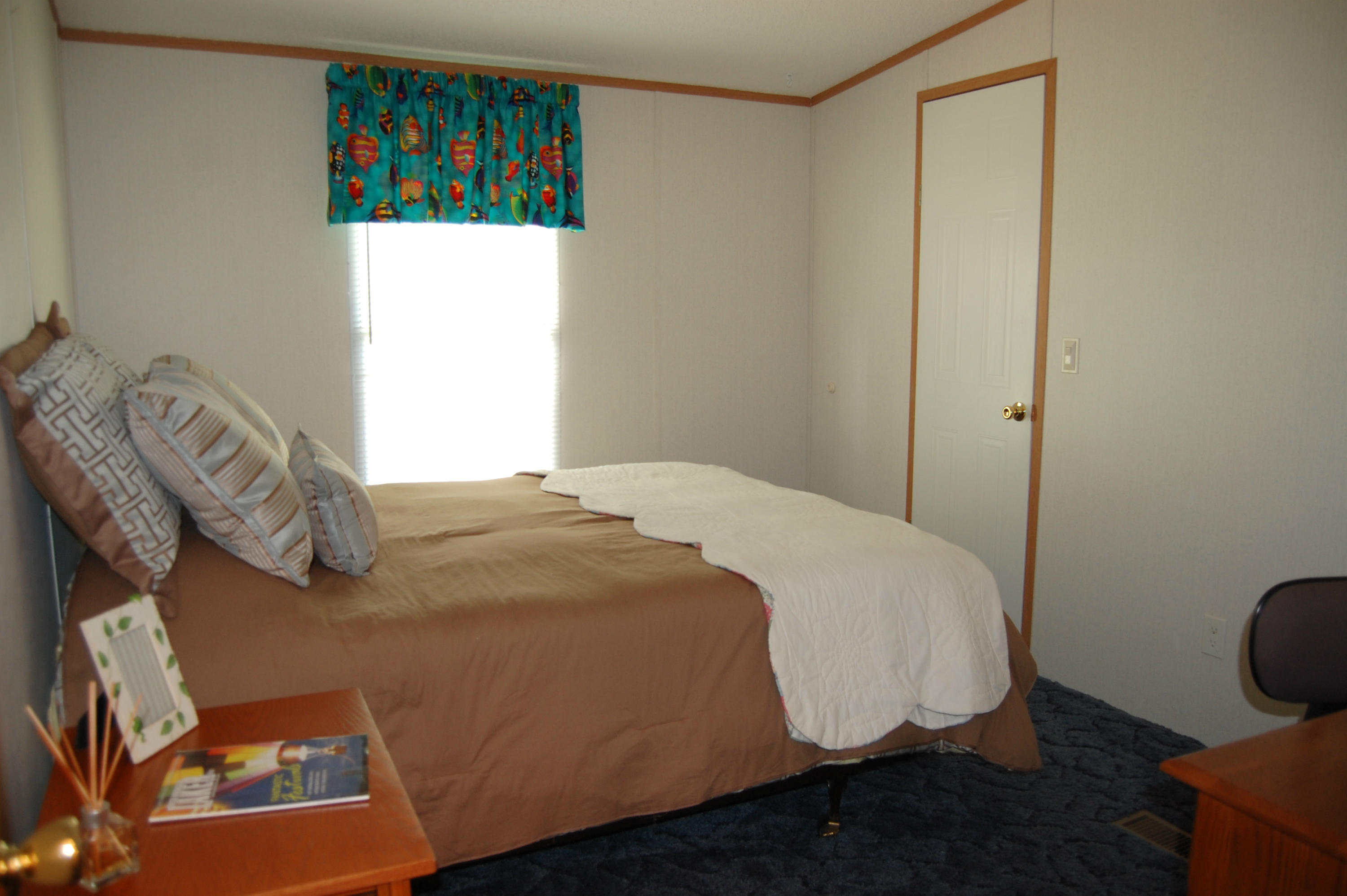 180 Cove Road Penhook, VA 24137 - Photo 26 of 33 a bedroom with a bed and a bookshelf