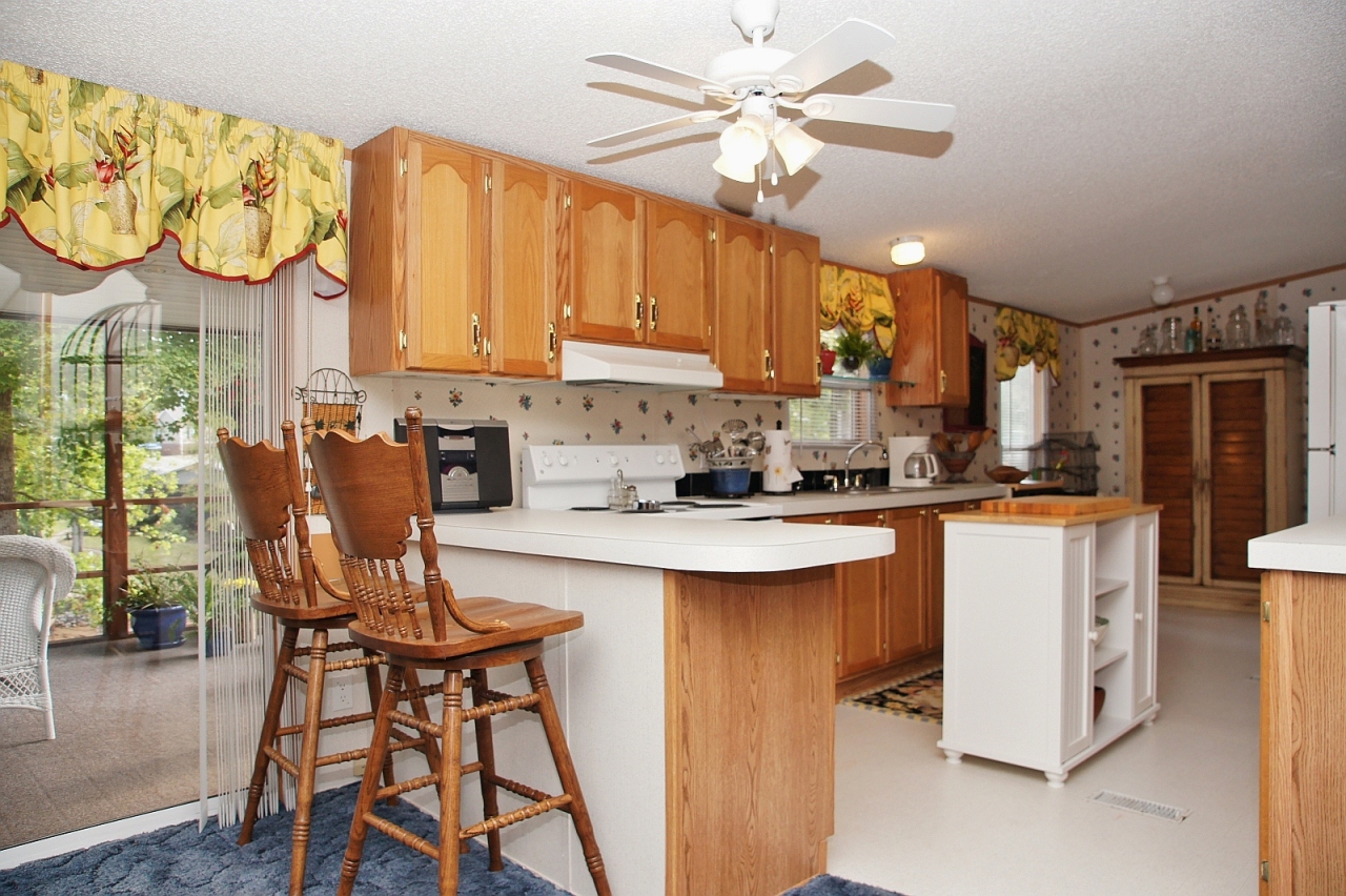 180 Cove Road Penhook, VA 24137 - Photo 4 of 33 a kitchen with stainless steel appliances granite countertop a table chairs and a chandelier