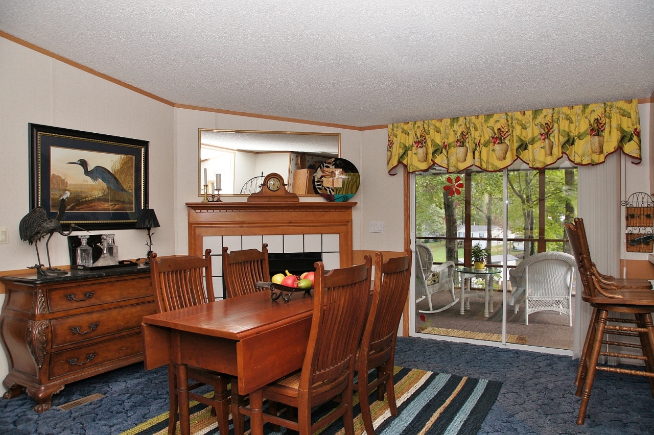 180 Cove Road Penhook, VA 24137 - Photo 7 of 33 a living room with furniture a flat screen tv and a fireplace