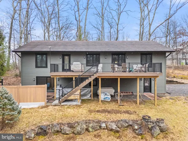 a view of a house with backyard porch and sitting area
