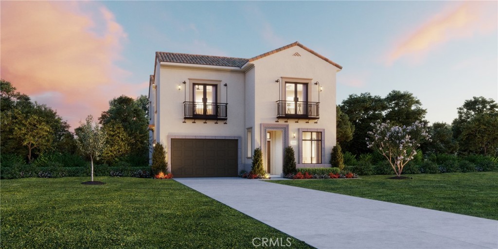 a front view of a house with a yard and trees