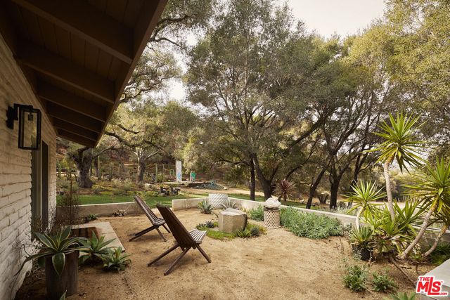 a view of patio with table and chairs and floor to ceiling window