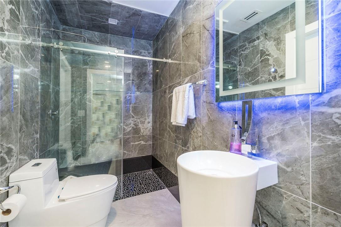 730 Northeast 69th Street Boca Raton, FL 33487 - Photo 24 of 32 a bathroom with a sink toilet and shower