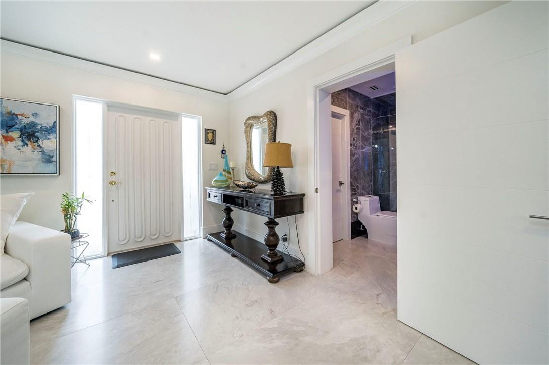 730 Northeast 69th Street Boca Raton, FL 33487 - Photo 25 of 32 a view of a livingroom with furniture and a flat screen tv