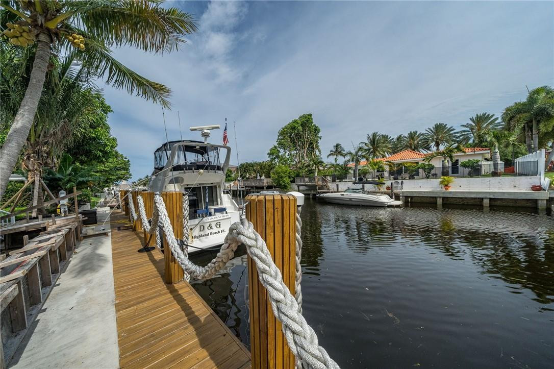 730 Northeast 69th Street Boca Raton, FL 33487 - Photo 26 of 32 a view of a house with outdoor space and a lake view