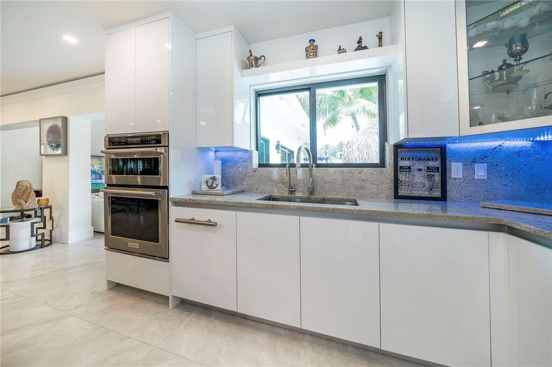 730 Northeast 69th Street Boca Raton, FL 33487 - Photo 5 of 32 a kitchen with stainless steel appliances a stove sink and microwave