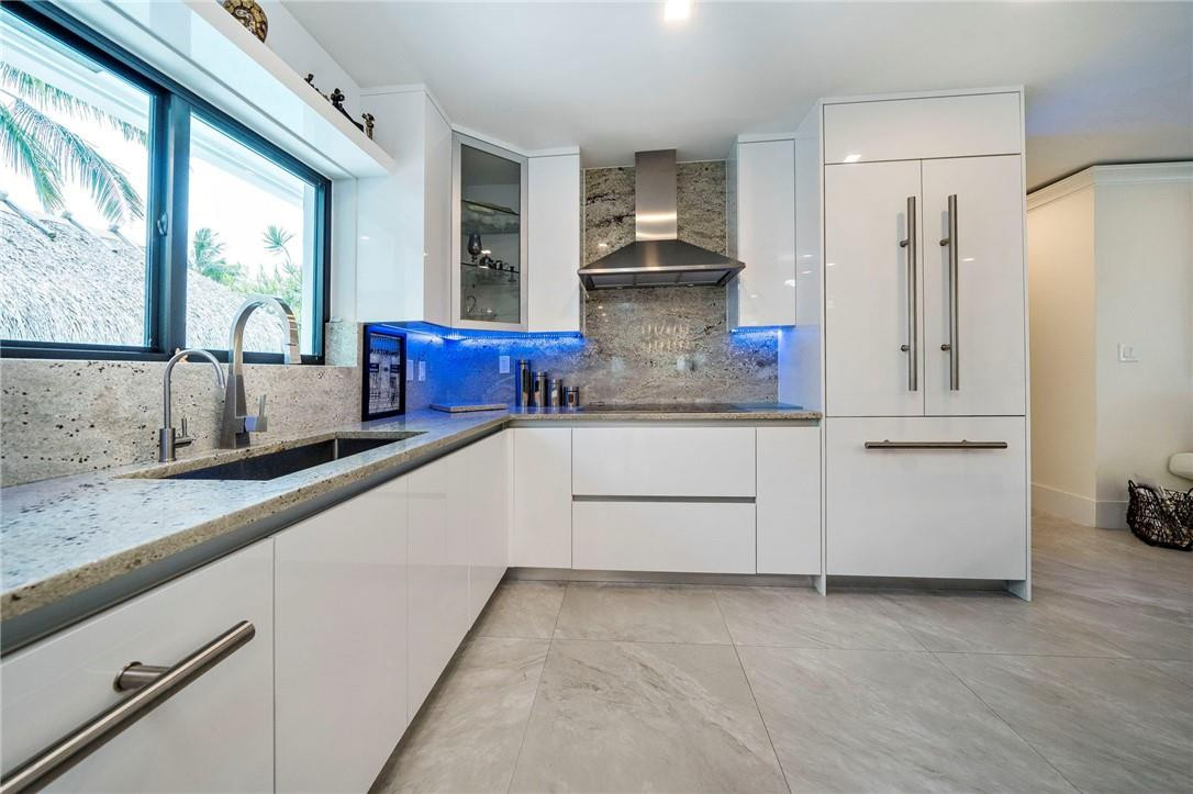 730 Northeast 69th Street Boca Raton, FL 33487 - Photo 6 of 32 a kitchen with white cabinets and a sink