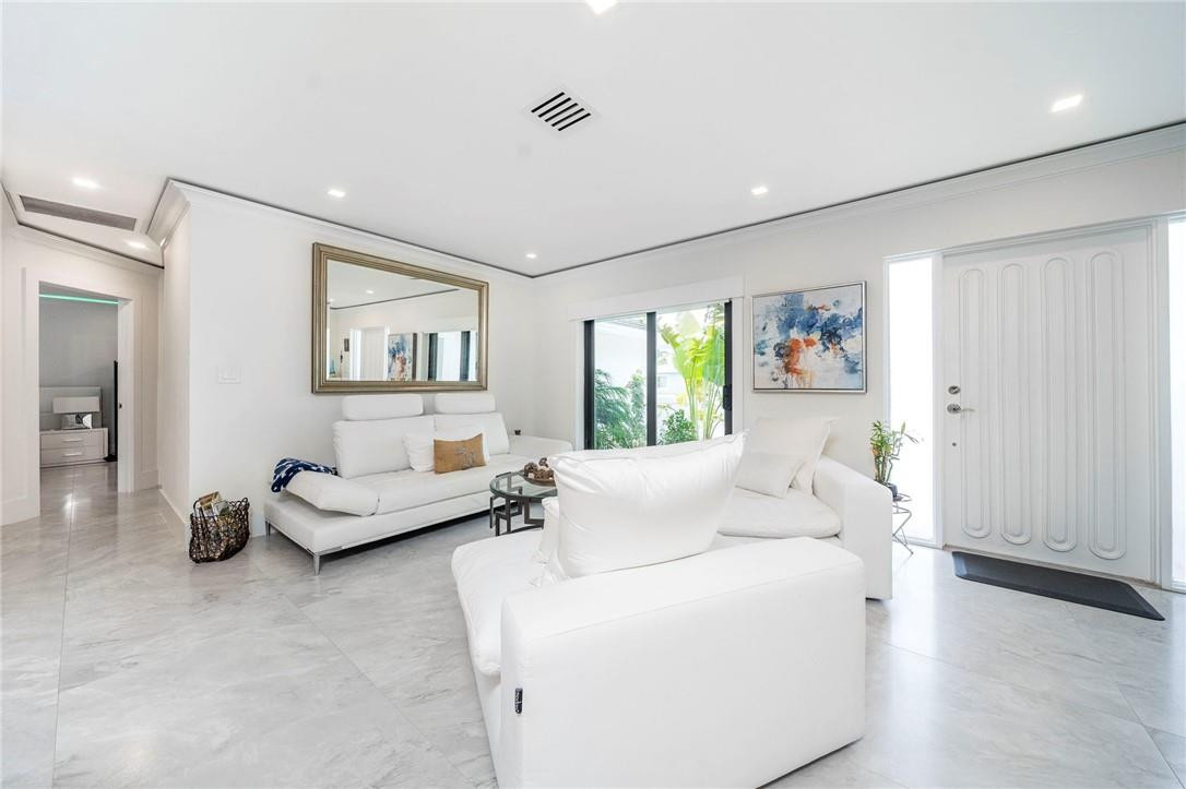 730 Northeast 69th Street Boca Raton, FL 33487 - Photo 10 of 32 a living room with furniture and a wooden floor